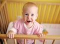 Joyfull child in crib