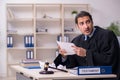 Young male judge working in courthouse