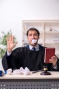 Young male judge working in courthouse