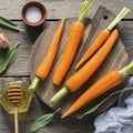 Young juicy carrots, sage, floral honey, garlic, salt ingredients for baking caramel spicy carrots. Top View.