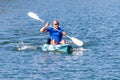 Young Kayaker Paddling Kayak. Sportsman kayaking Blue Water