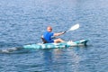 Young Kayaker Paddling Kayak. Sportsman kayaking Blue Water