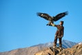 Young kazakh eagle hunter with his golden eagle Royalty Free Stock Photo