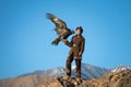 Young kazakh eagle hunter with his golden eagle Royalty Free Stock Photo