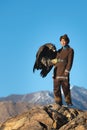 Young kazakh eagle hunter with his golden eagle Royalty Free Stock Photo
