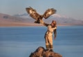 Young kazakh eagle hunter with his golden eagle Royalty Free Stock Photo