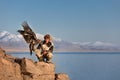 Young kazakh eagle hunter with his golden eagle Royalty Free Stock Photo