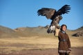 Young kazakh eagle hunter with his golden eagle Royalty Free Stock Photo