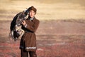 Young kazakh eagle hunter with his golden eagle Royalty Free Stock Photo