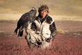 Young kazakh eagle hunter with his golden eagle Royalty Free Stock Photo