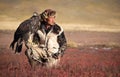 Young kazakh eagle hunter with his golden eagle Royalty Free Stock Photo