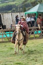 Young kechwa cowboy in traditional wear on horseback