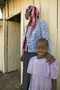 A young Kenya girl, infected with HIV/AIDS, stands beside Khadija Rama, founder of Pepo La Tumaini Jangwani, HIV/AIDS Community Re Royalty Free Stock Photo