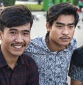 Young Khmer men sit along Phnom Penh\'s Riverside wall,at sunset