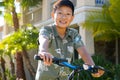 Young kid Asian boy with braces on his bike in front of the house Royalty Free Stock Photo