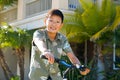 Young kid Asian boy with braces on his bike in front of the house Royalty Free Stock Photo
