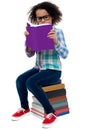 Young kid concentrating while reading a book Royalty Free Stock Photo