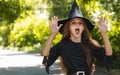 Young kid dressed up for Halloween festival. Portrait little girl in a witch costume, outside Royalty Free Stock Photo