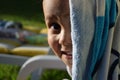 Young kid smiling to the camera after a nice bath in a swimming pool