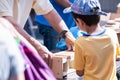 Young kid holding a hammer building bird house