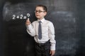 Young kid`s solving math`s expression. Back to school concept. Augmented reality. Smart and clever preschool boy. Royalty Free Stock Photo