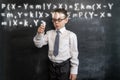 Young kid`s writing a long math`s formula. Back to school concept. Augmented reality. Smart and clever preschool boy. Royalty Free Stock Photo