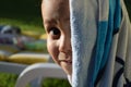 Young kid smiling to the camera after a nice bath in a swimming pool