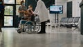 Young kid visiting old woman in wheelchair during covid 19 pandemic Royalty Free Stock Photo