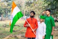 Young kids and boy of different age and different religion hearing tricolor dress and holding Indian National flag. Royalty Free Stock Photo