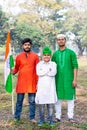 Young kids and boy of different age and different religion hearing tricolor dress and holding Indian National flag. Royalty Free Stock Photo