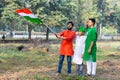 Young kids and boy of different age and different religion hearing tricolor dress and holding Indian National flag. Royalty Free Stock Photo