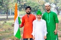 Young kids and boy of different age and different religion hearing tricolor dress and holding Indian National flag. Royalty Free Stock Photo