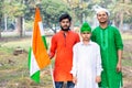 Young kids and boy of different age and different religion hearing tricolor dress and holding Indian National flag. Royalty Free Stock Photo