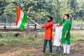 Young kids and boy of different age and different religion hearing tricolor dress and holding Indian National flag. Royalty Free Stock Photo