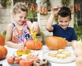 Young kids carving Halloween Jack-o-lanterns Royalty Free Stock Photo