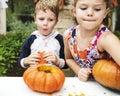 Young kids carving Halloween jack-o`-lanterns Royalty Free Stock Photo