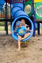 Young kids exiting a tube slide Royalty Free Stock Photo