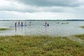 Young kids learning to paddle board