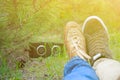 Young kissing happy couple in love sitting on the ground and listening music in green sammer park Royalty Free Stock Photo