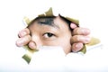 Young Korean man looking through ripped paper hole Royalty Free Stock Photo