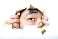 Young Korean man looking through ripped paper hole Royalty Free Stock Photo