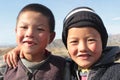 Young kyrgyz brothers looking into the camera, kyrgyzstan, portrait of two friends