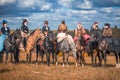 Young ladies in 19th century dresses riding horseback