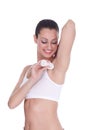 Young lady applying deodorant on armpits Royalty Free Stock Photo