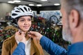 young lady being fitted with bicycle helmet Royalty Free Stock Photo