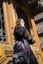 Young lady in black coat with long beautiful hair speaking on a phone Royalty Free Stock Photo