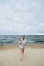 Young lady with dog near sea Royalty Free Stock Photo