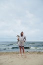 Young lady with dog near stormy sea Royalty Free Stock Photo