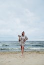Young lady with dog near stormy sea Royalty Free Stock Photo