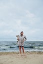 Young lady with dog near stormy sea Royalty Free Stock Photo